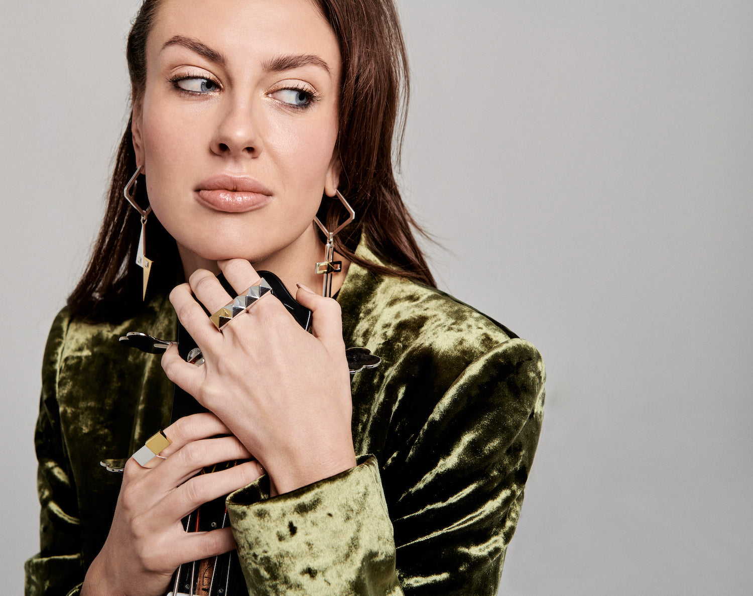 Cirkl's mix n match principle featured in this image with model wearing 4 statement pieces. Rebel Rebel stud ring, plus a uniquely designed glamrock inspired statement ring and, 2 statement earrings featuring asymmetrical styling.